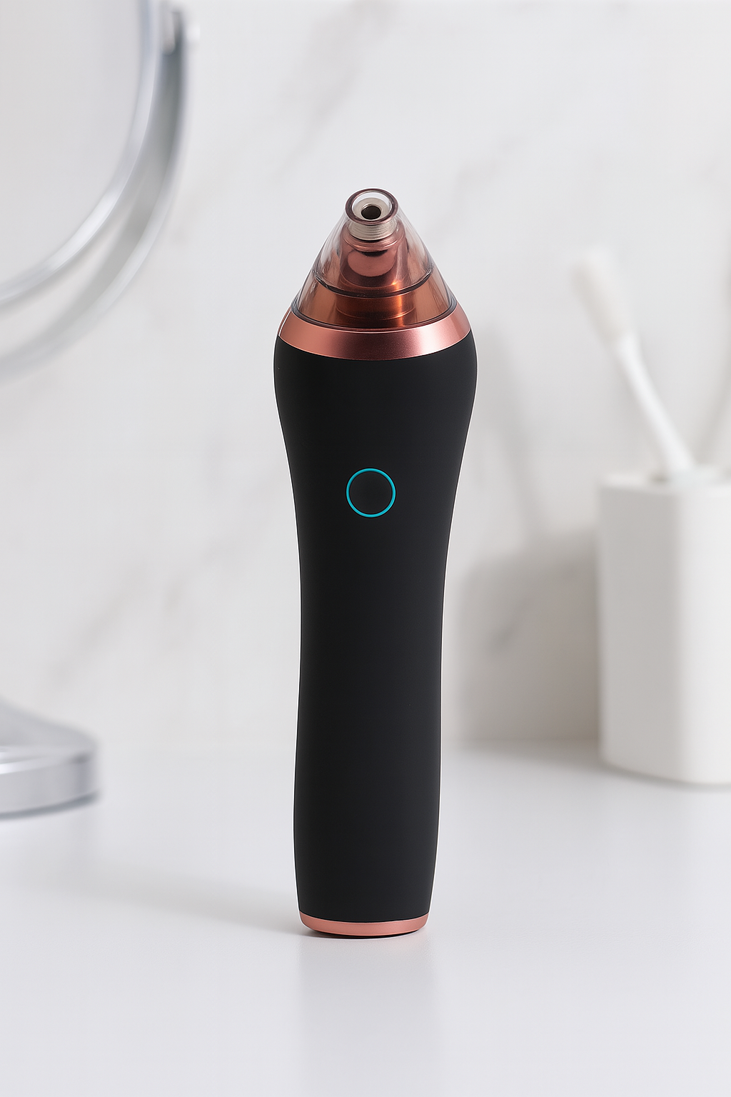 Black and rose gold pore vacuum device standing upright on a bathroom counter