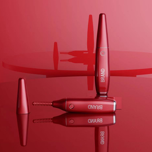 Red electric heated eyelash curler with spiral heating brush, displayed upright and horizontally on a reflective red surface with a cap beside it.