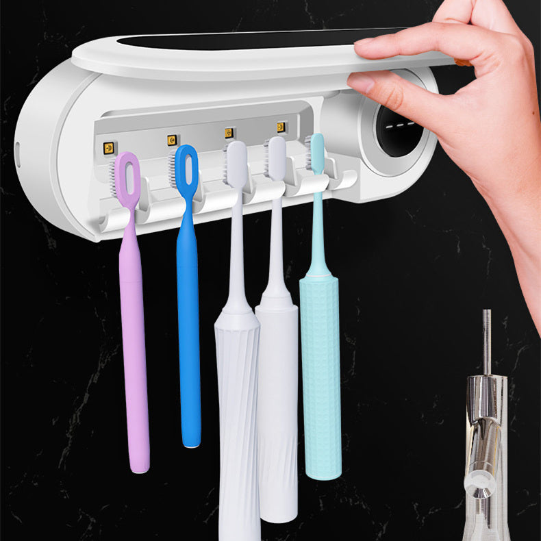 Wall mounted toothbrush and accessory holder with multiple toothbrushes and a hand adjusting the lid.