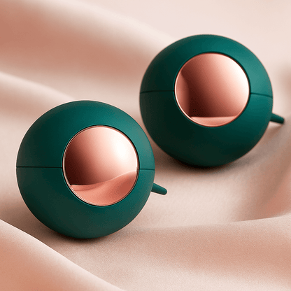 Two green reusable lint remover balls on neutral background
