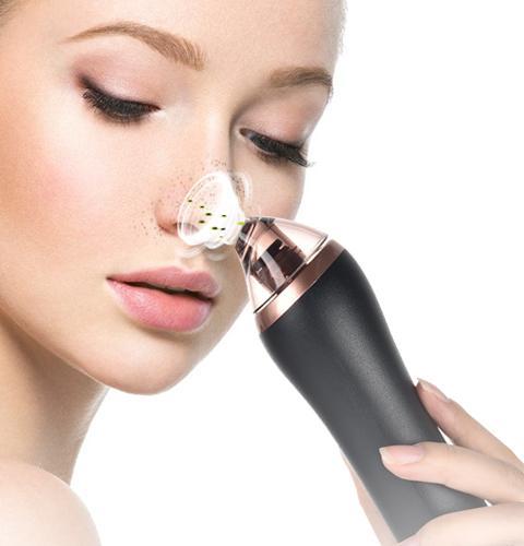 Close-up of woman cleansing skin with white pore vacuum device for facial exfoliation