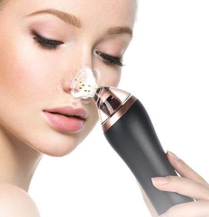 Close-up of woman cleansing skin with white pore vacuum device for facial exfoliation